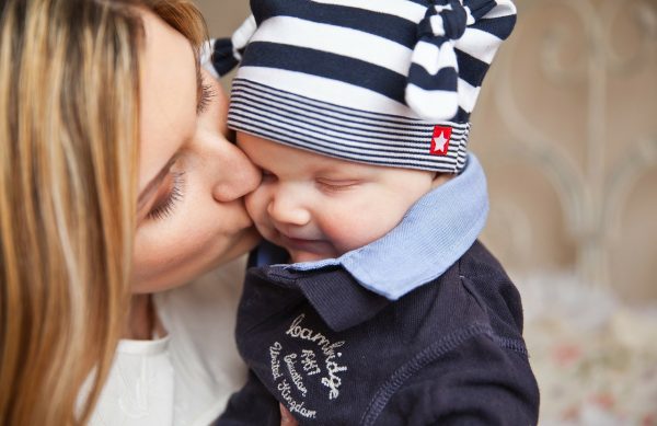 Mother kissing a child