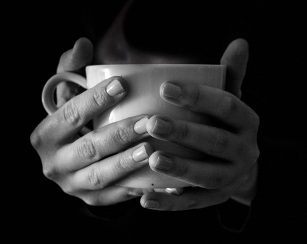 hands are holding cup of coffee
