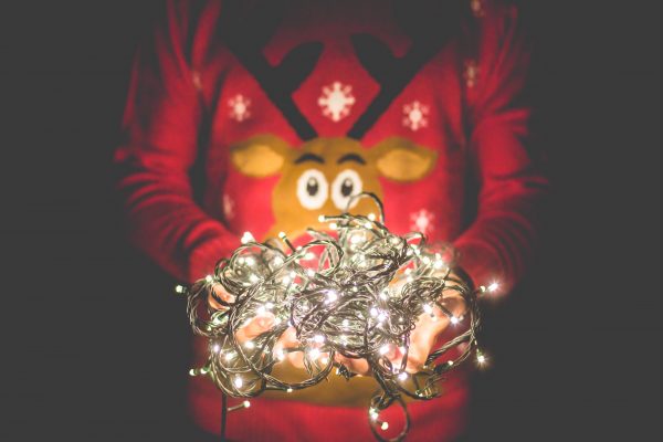 man holding christmas lights