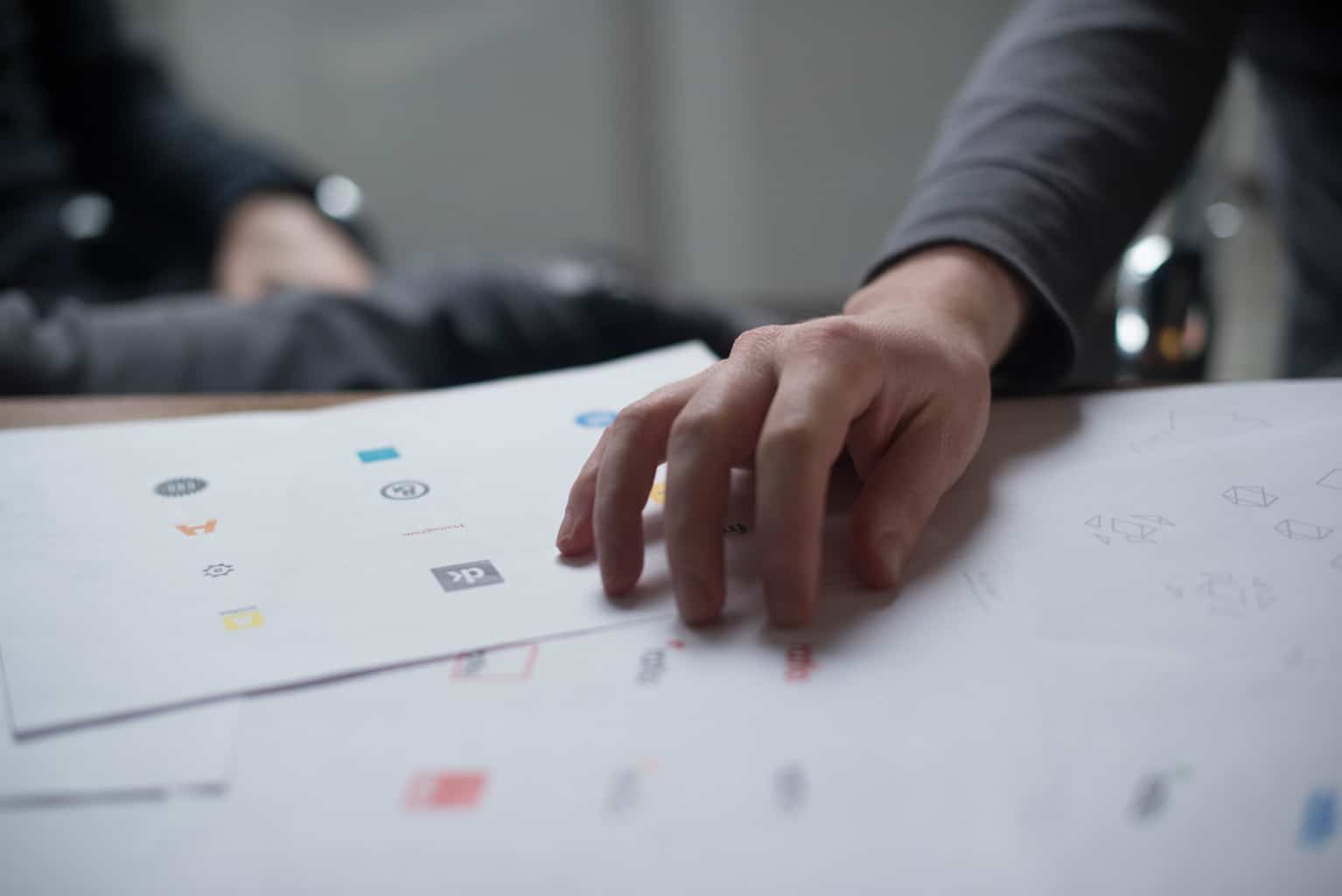 Logo designer hand on paper